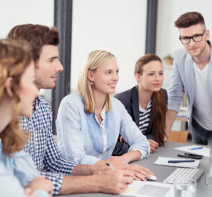 Five,Young,Office,Workers,Reading,Something,On,Computer,Together,While