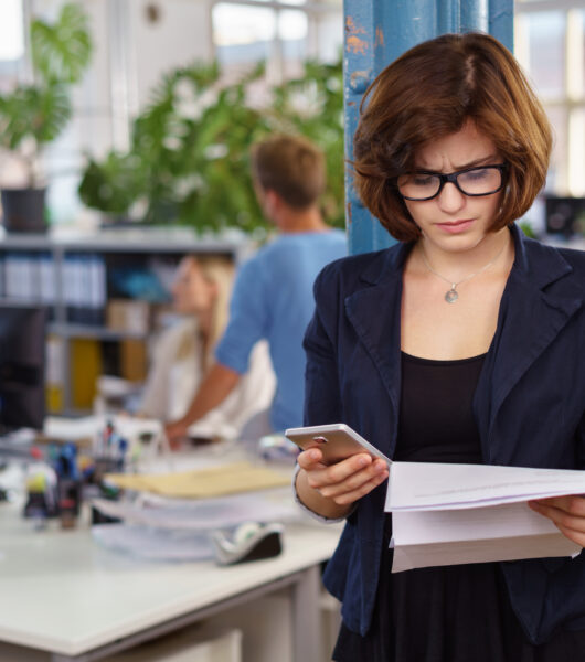 Businesswoman,Reading,A,Document,In,The,Office,As,She,Prepares