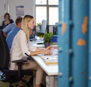 Side,View,Of,Young,Woman,Work,Among,Colleagues,In,Open